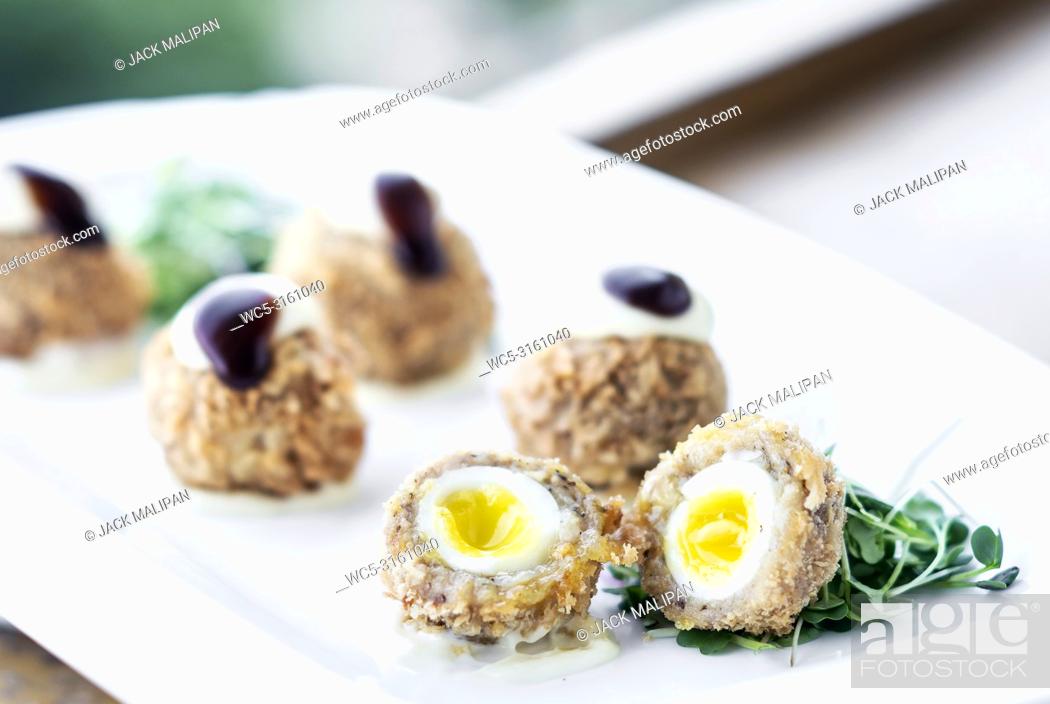 Stock Photo: gourmet organic scotch quail eggs modern starter snack dish on table.