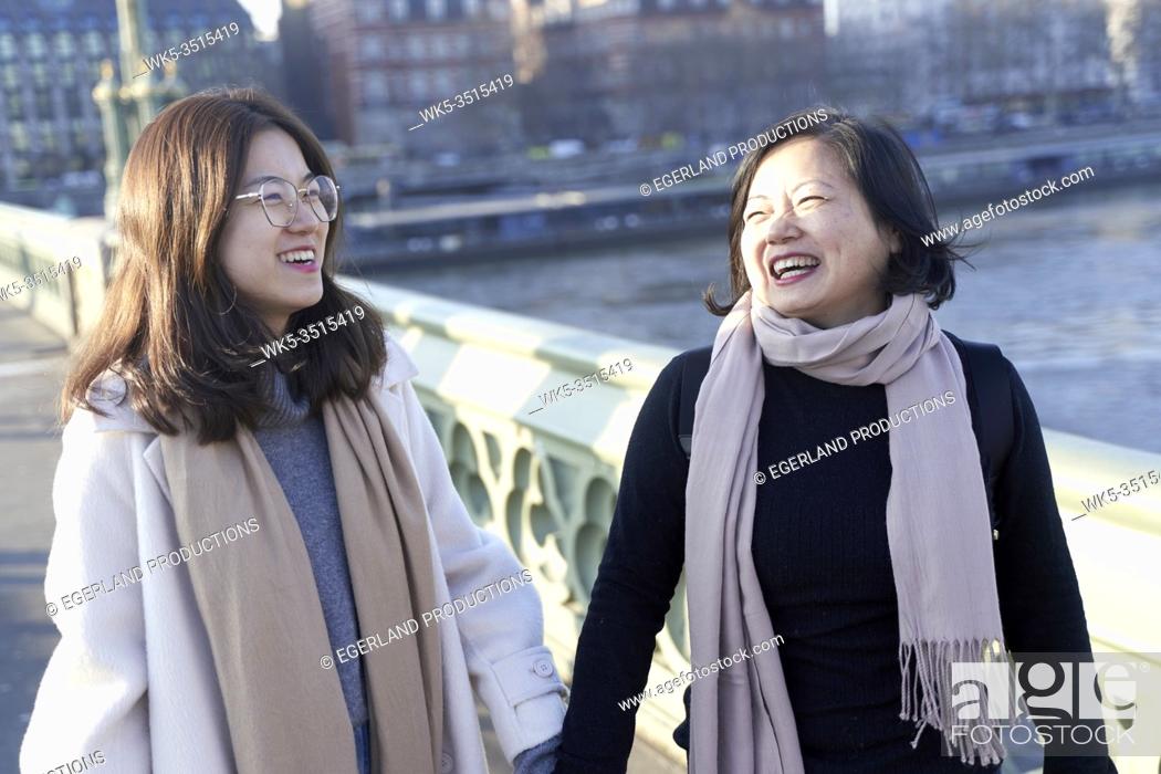 Stock Photo: Asian mother and daughter walking in London, UK.