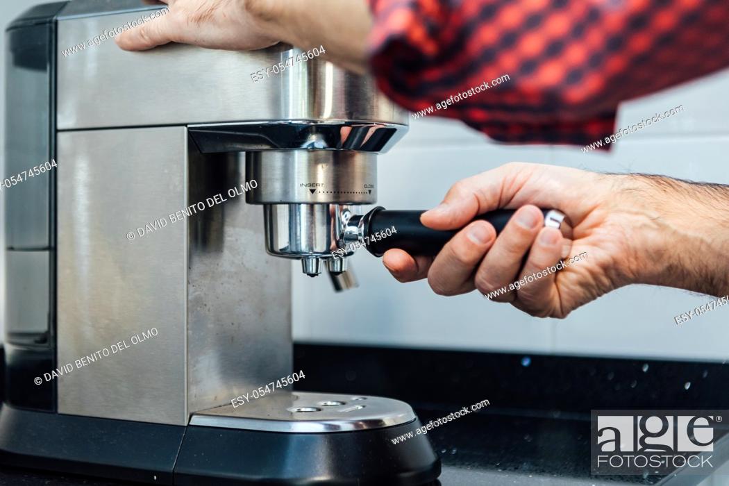Stock Photo: Detail of man's hands preparing an espresso.