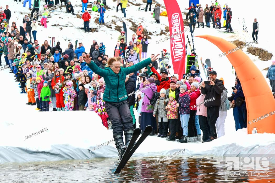 Stock Photo: RUSSIA, IVANOVO REGION - APRIL 2, 2023: A skier lands in water during the 2023 edition of Easy-Freezy Festival at Milovka ski resort in the town of Plyos in.
