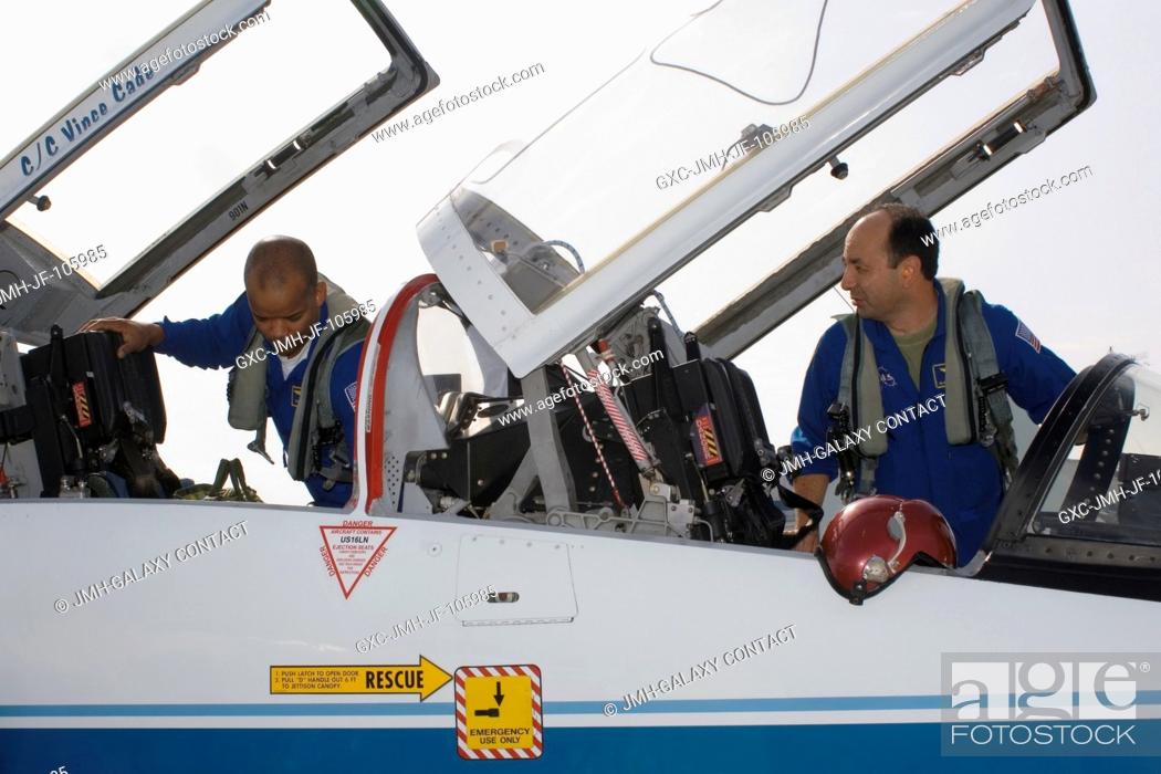 Stock Photo: Astronauts Mark L. Polansky (right), STS-116 commander, and Robert L. Curbeam, mission specialist, go through a pre-flight check of the systems of a NASA T-38.