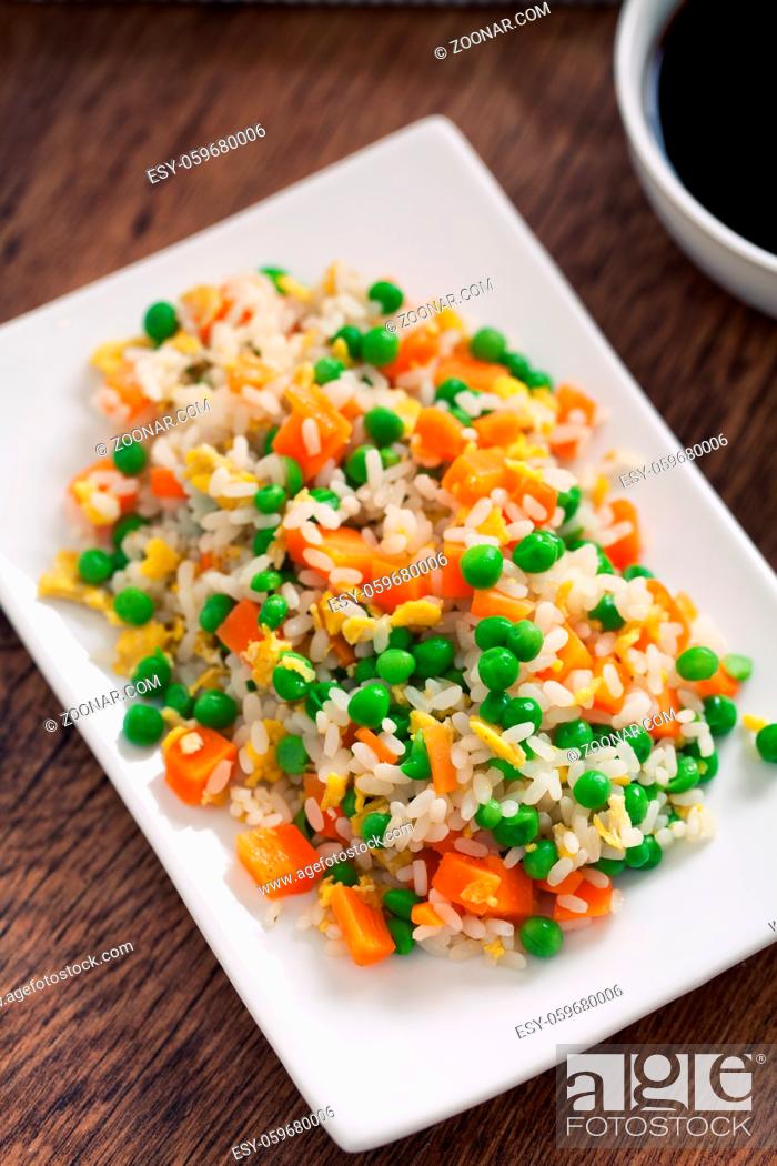 Stock Photo: Oriental cantonese rice. Basmati rice with green peas, eggs and carrots.