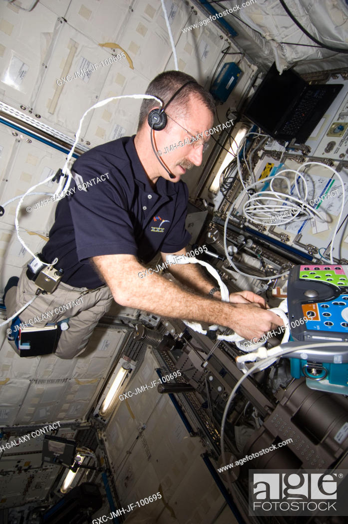 Stock Photo: NASA astronaut Dan Burbank, Expedition 30 commander, sets up the Integrated Cardiovascular (ICV) Resting Echo Scan at the Human Research Facility (HRF) rack in.