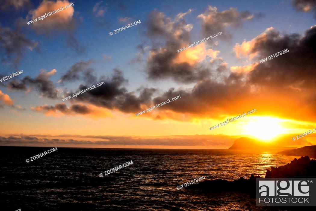 Stock Photo: Cloudscape, Colored Clouds at Sunset near the Ocean.