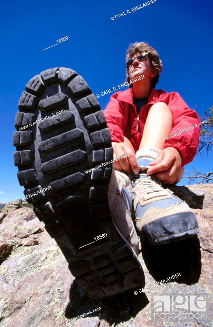 Stock Photo: Woman tying shoelaces of boots during hike, Chiricahua National Monument, Arizona, USA.