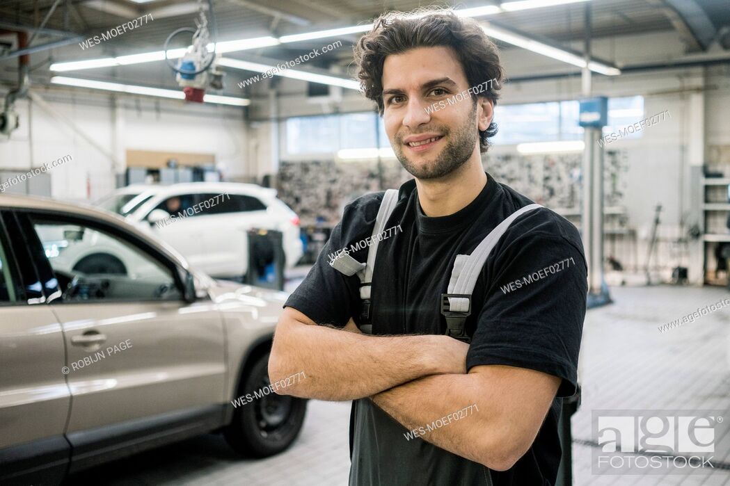 Stock Photo: Portrait of a smiling car mechanic in a workshop.