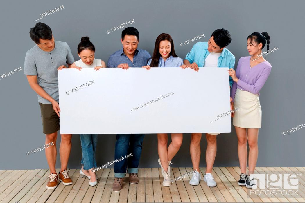 Stock Photo: In the happy young man holding a whiteboard.