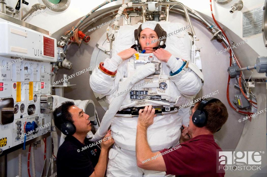 Stock Photo: NASA astronaut Sandy Magnus, STS-135 mission specialist, participates in an Extravehicular Mobility Unit (EMU) spacesuit fit check in the Space Station Airlock.