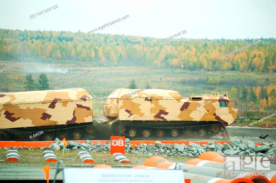 Stock Photo: Nizhniy Tagil, Russia - September 25. 2013: Tracked carrier DT-30P1 on demonstration range. It leaves after overcoming of water ford.