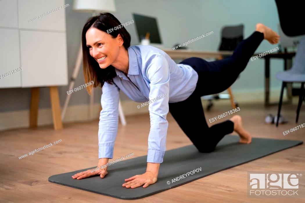 Stock Photo: Yoga Leg Workout In Office Near Desk And Computer.
