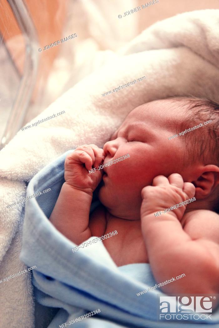 Stock Photo: Shirtless, Eyes Closed, Scandinavia, Ward, View From Above, Kid, Uppsala, Head And Shoulders, Waist-Up, Lying Down, Portrait, Vertical, Child, Indoors, Girl, Baby, Innocence, Sleep, Newborn, Blue, Color Image, One Person, Nursery, Day, Cute, Maternity Ward, Sweden