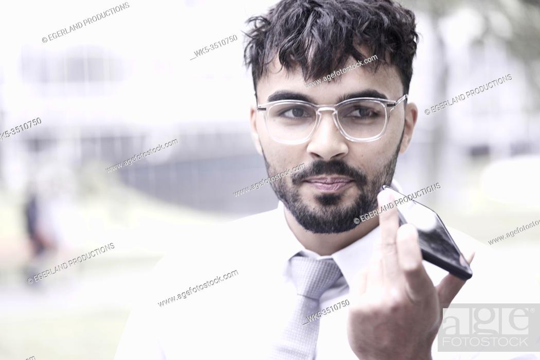 Stock Photo: obstinate businessman on the street, talking on phone.