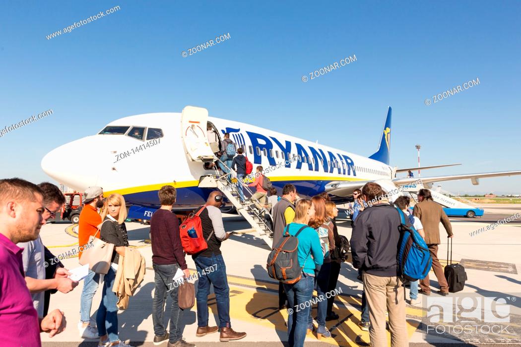 Stock Photo: Trieste airport, Italy - 20 April 2018: People boarding Ryanair plane on Friuli Venezia Giulia Airport in Trieste, italy on April 20th, 2018.