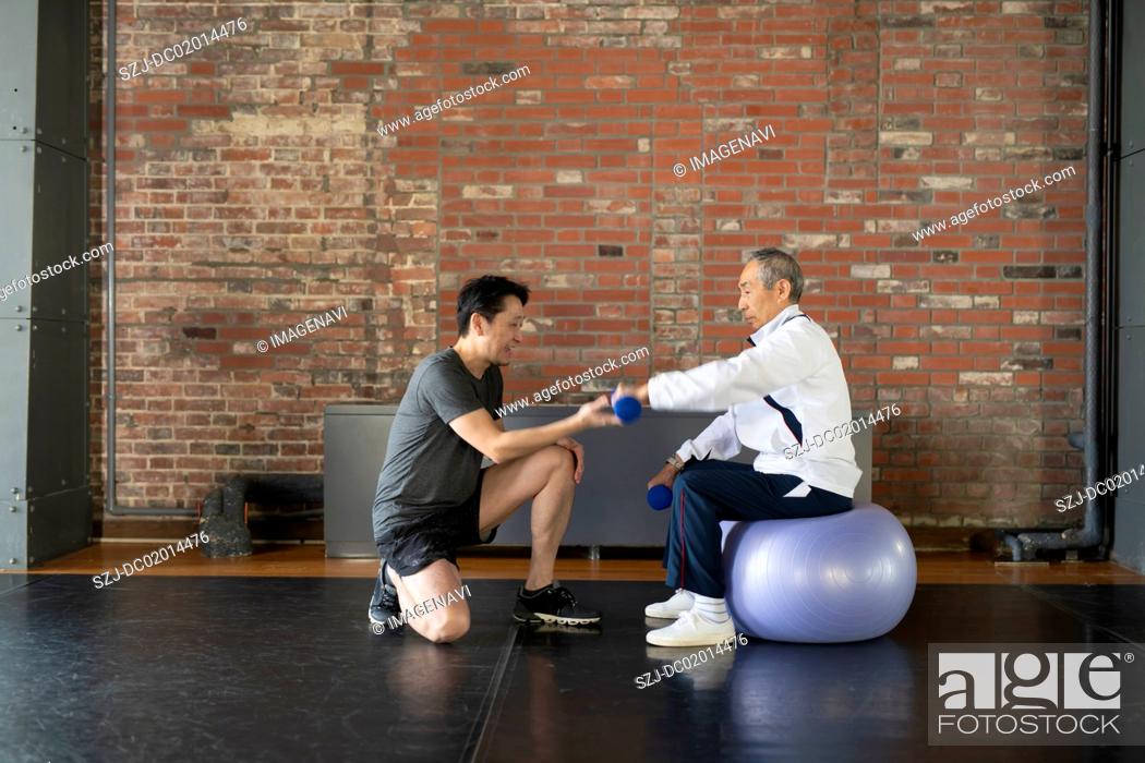 Stock Photo: Senior man taking personal training.
