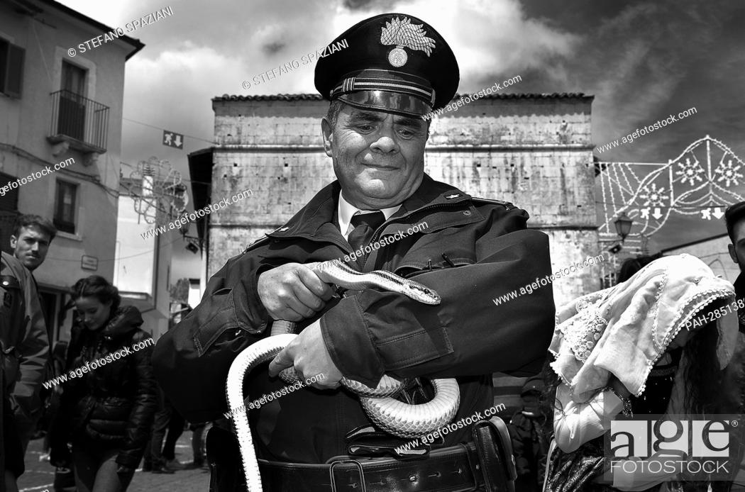 Stock Photo: After two years of interruption due to the pandemic, the procession of snakes in Cocullo takes place on 1 May 2022.the police officer of Cocullo with snakes in.