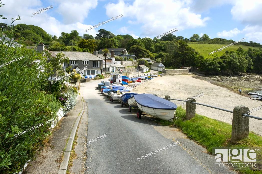 Stock Photo: Many colourful small boats line up along the roadside beach edge in the popular launching place of Helford Passage, Cornwall, UK.
