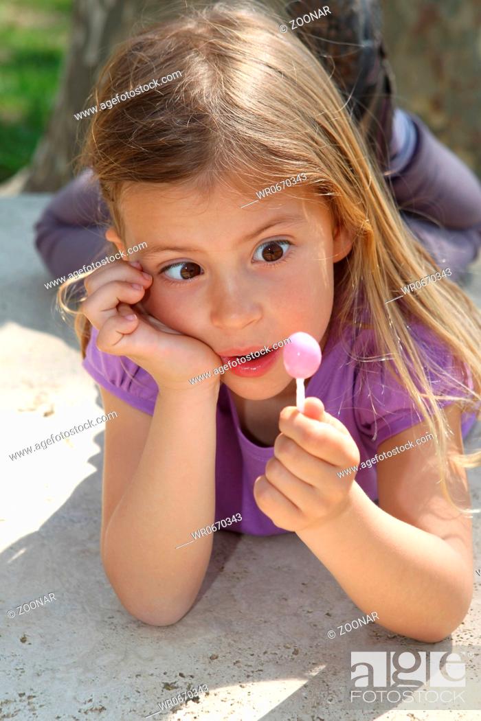 Stock Photo: Girl looking at lollipop.