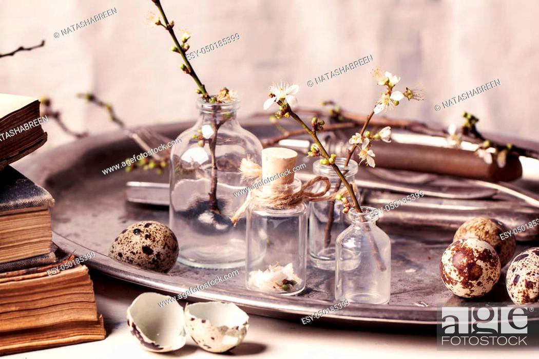 Stock Photo: Fragment of Easter interior with little glass vials, blossom branch and quail eggs. See series.