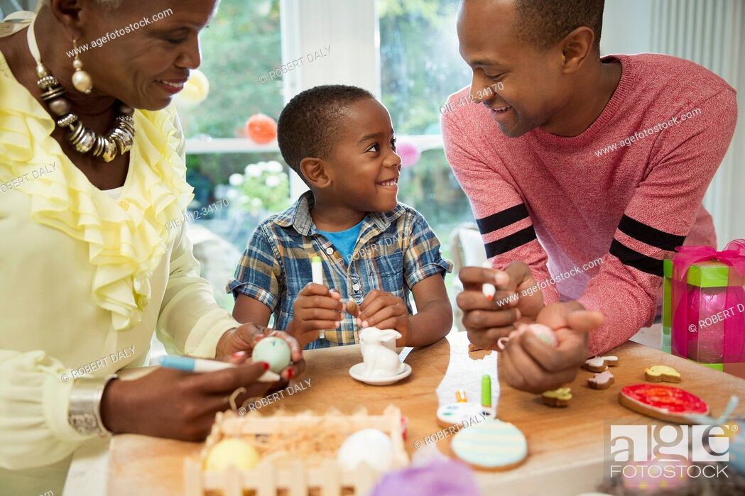 Stock Photo: Multi-generation family decorating Easter eggs and cookies.