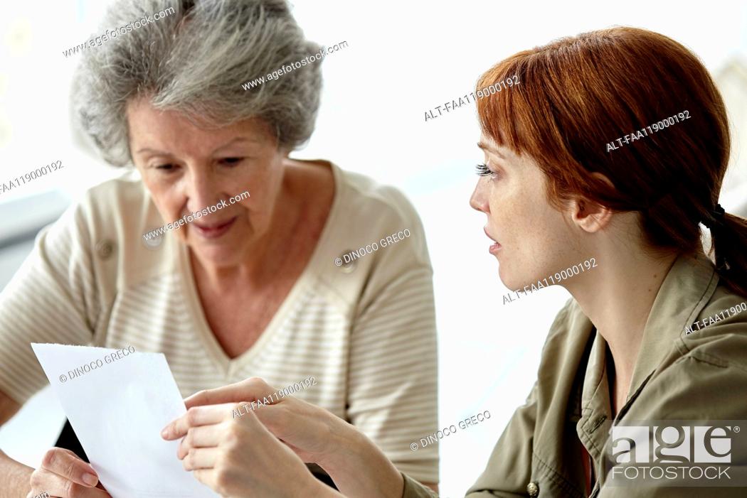 Stock Photo: Mother and daughter discussing over prescription.