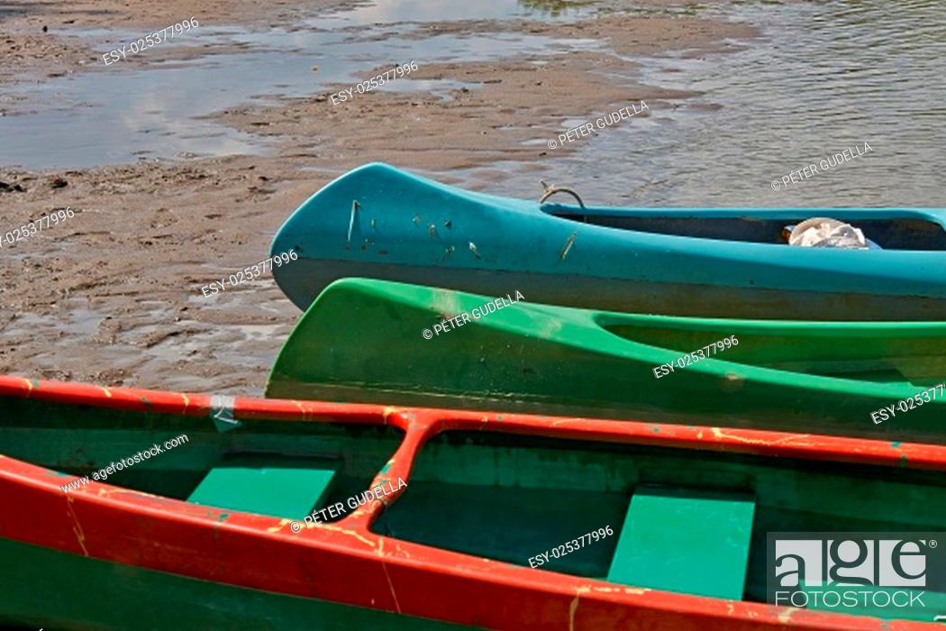 Stock Photo: Canoes parked on the riverside.