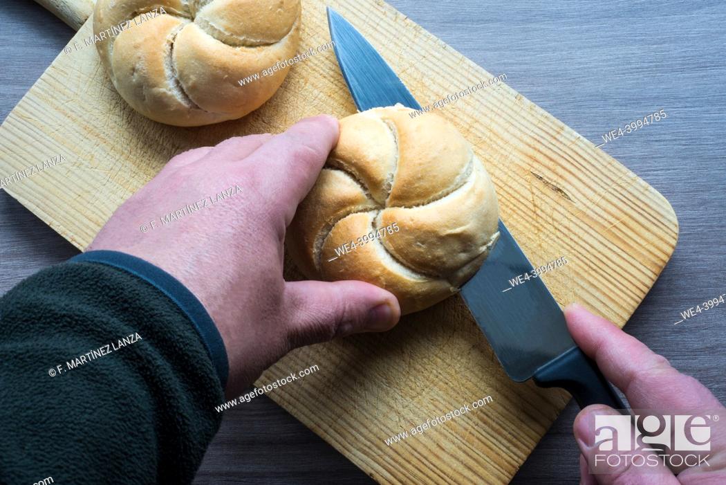 Stock Photo: Man hands preparing a sandwich.