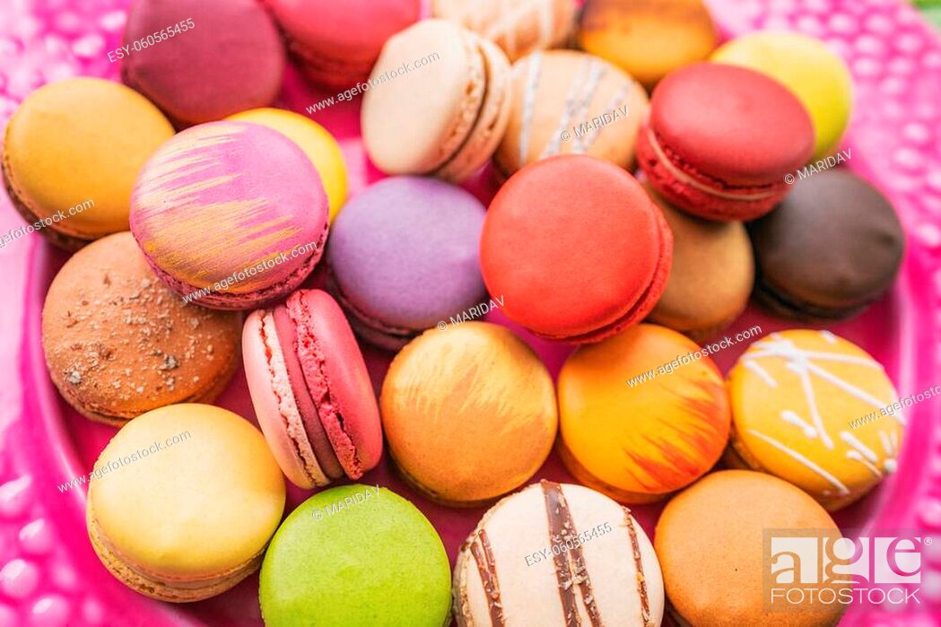 Stock Photo: Many macarons closeup on table. Numerous colorful french macaron pastries.