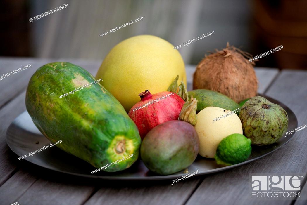 Stock Photo: A papaya, mango, nashi pear, physalis, pomelo, cherimoya, coconut and lime seen on a fruit plate in Cologne, Germany, 07 December 2016.