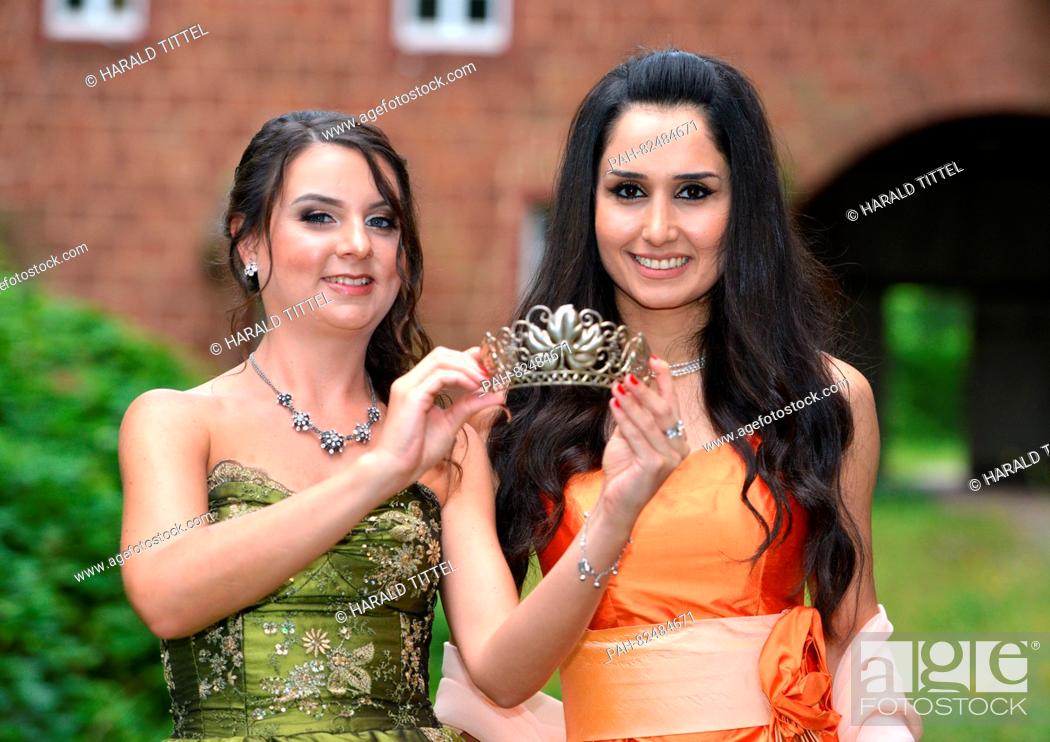 Stock Photo: The new Wine Queen of Trier, Ninorta Bahno (26, R) from Syria, and her predecessor Sandra Roth (L) look at the crown ahead of the official crowning in Trier.