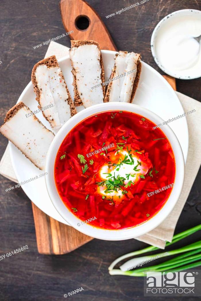 Stock Photo: Ukrainian red national dish borsch, beet soup, added to Unesco list. Borscht with sour cream. Beetroot borscht with parsley.