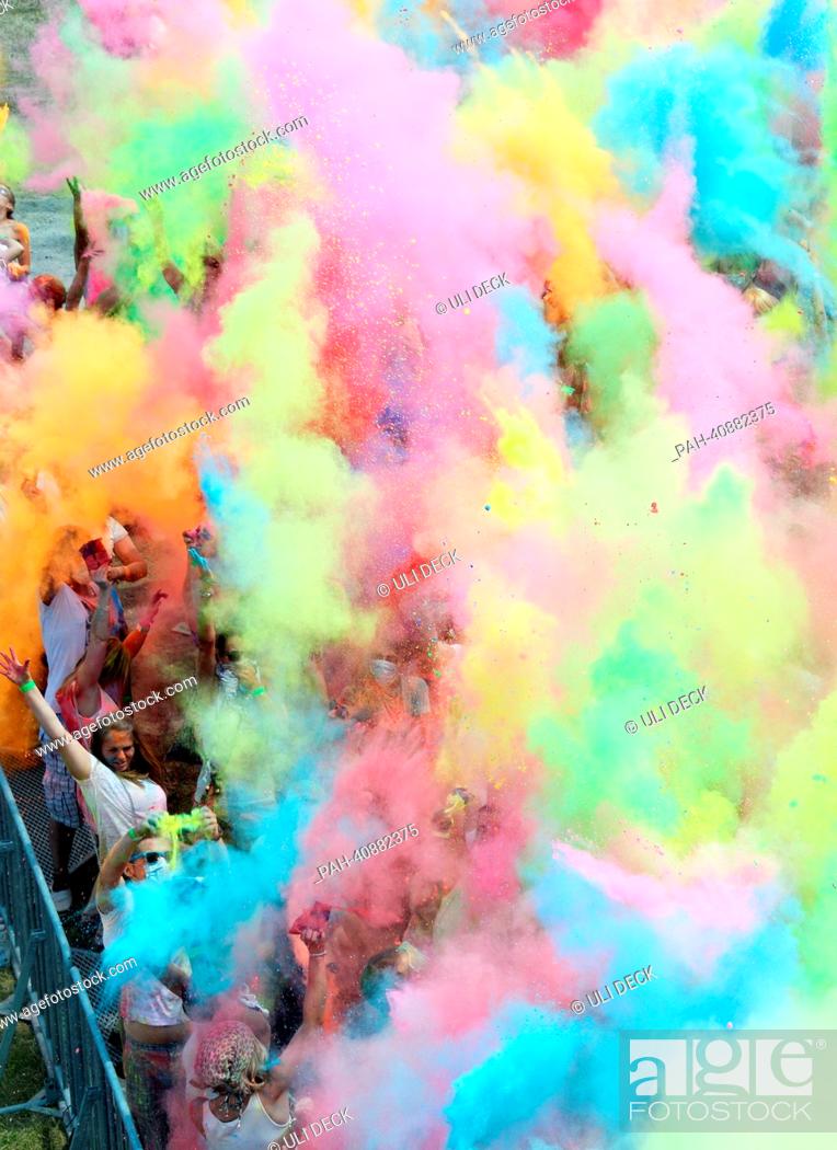 Visitors of the Holi Festival of Colours throw special colored powders in  the air on a meadow near..., Stock Photo, Picture And Rights Managed Image.  Pic. PAH-40882375 | agefotostock