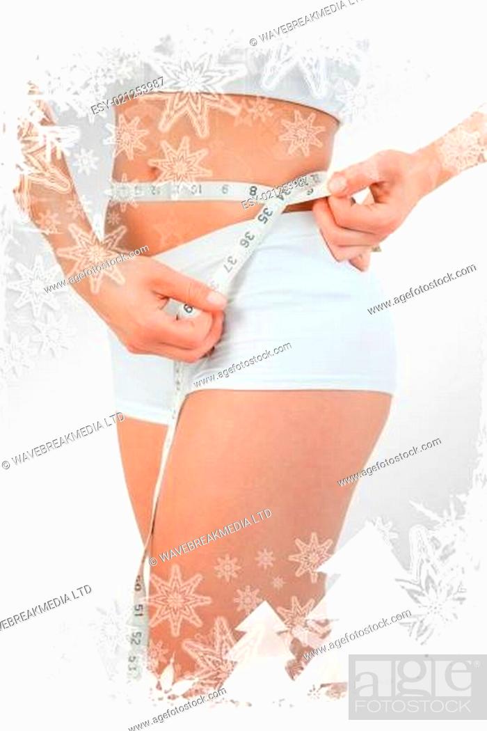 Stock Photo: Composite image of portrait of a woman using a measuring tape.