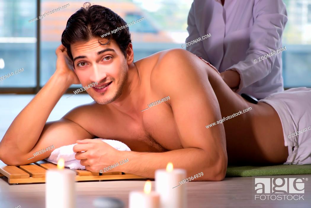 Stock Photo: Young handsome man during spa procedure.