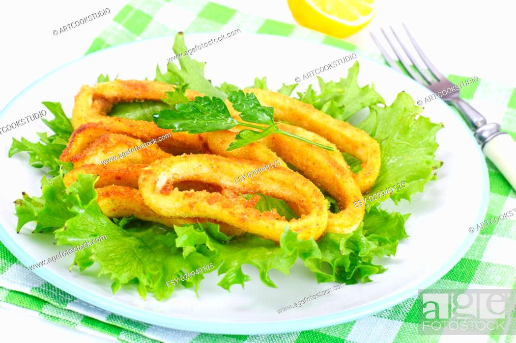 Stock Photo: Fried Squid Rings in Breadcrumbs with Lettuce and Lemon Studio Photo.