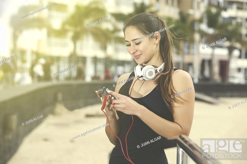 Stock Photo: Woman changing song.