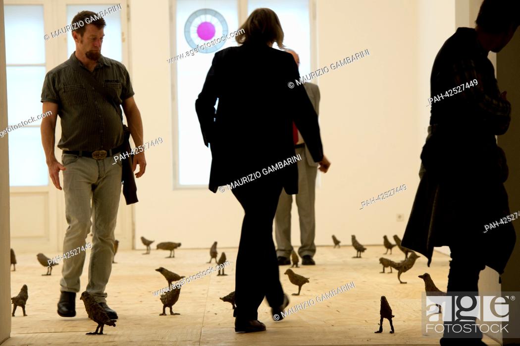 Stock Photo: Visitors walk through the exhibition 'Primitive' from 2012 by Ugo Rondinone in the exhibition 'The End of the 20th Century. The Best Is Yet to Come.