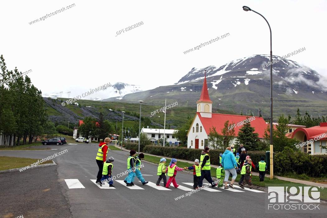 Stock Photo: GROUP OF SCHOOLCHILDREN IN THE STREETS IN THE CITY OF REYDARFJORDUR NEAR THE ALCOA ALUMINUM FACTORY, CONTROVERSIAL PROJECT BECAUSE OF ECOLOGICAL DAMAGE.