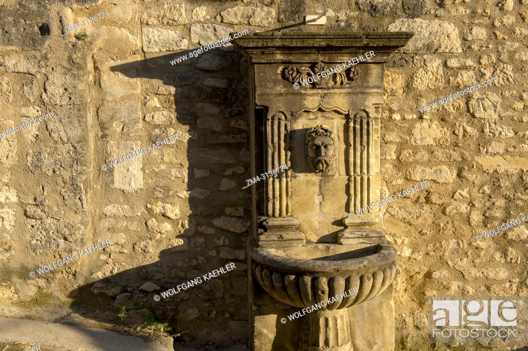 Stock Photo: A village scene with a fountain in the hillside village of Lacoste in the Luberon in the Provence-Alpes-Cote d Azur region in southeastern France.