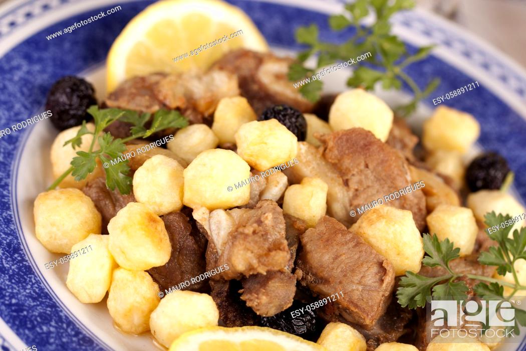 Stock Photo: Close up view of a Portuguese meal of cooked meat with potatoes.