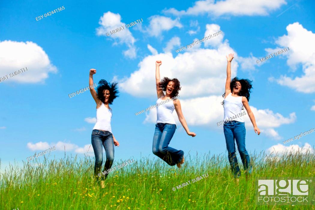Stock Photo: Girl group jumping in the air.