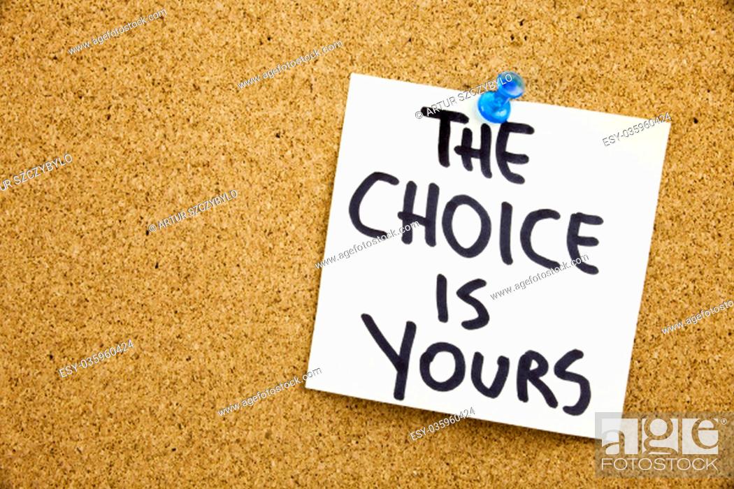 Stock Photo: Phrase THE CHOICE IS YOURS in black ext on a sticky note pinned to a cork notice board.