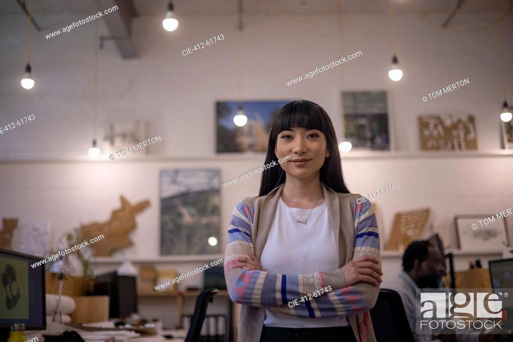 Imagen: Portrait confident female designer standing in office.