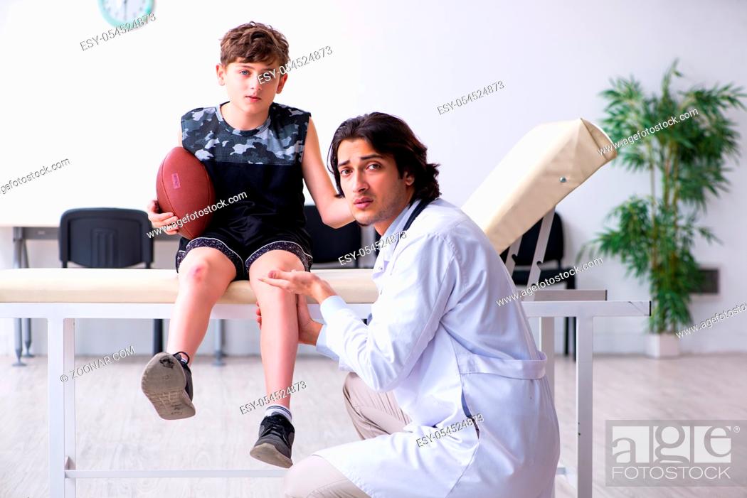 Stock Photo: The boy american football player visiting young doctor traumatologis.