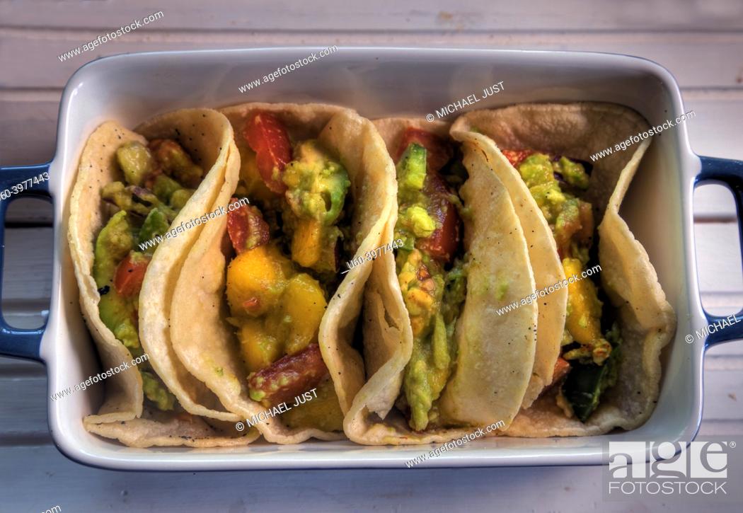 Stock Photo: Top view of tacos with mango, avocado, jalapeno, tomato and red onion.