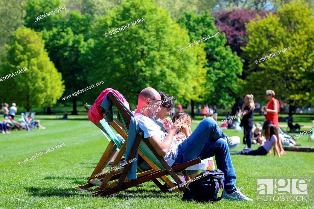 Stock Photo: Hot weather continues in the capital. Tourists and Londoners enjoy the hot weather in St James’s Park as temperatures reach 21 degrees celsius in London.