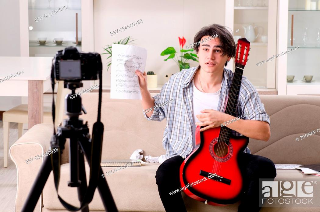 Stock Photo: The young guitar player recording video for his blog.
