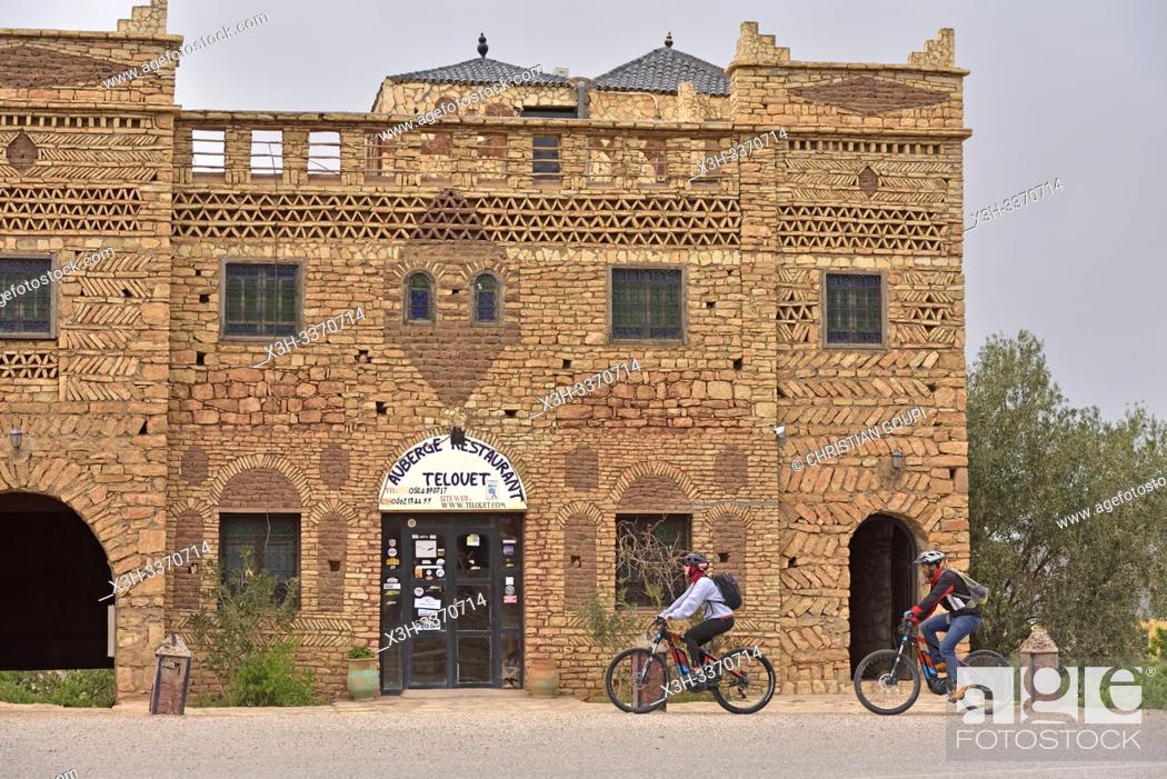 Stock Photo: cyclist in front of the ''Auberge-restaurant'' in the village of Telouet, Ouarzazate Province, region of Draa-Tafilalet, Morocco, North West Africa.