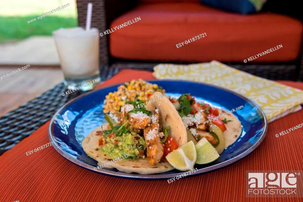 Stock Photo: Assembled Fajitas with Mexican Street Corn and a Margarita.