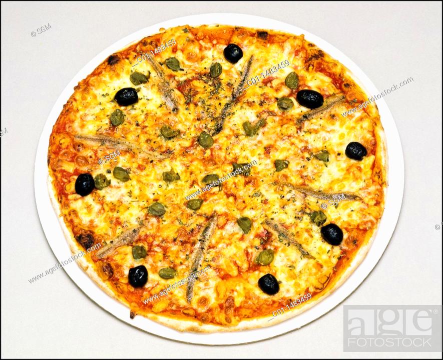 Stock Photo: Whole Neapolitan pizza with anchovies, black olives, capers, cheese and tomato.