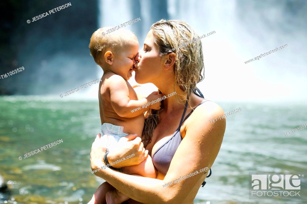 Imagen: Mother kissing baby (18-23 months) with love.